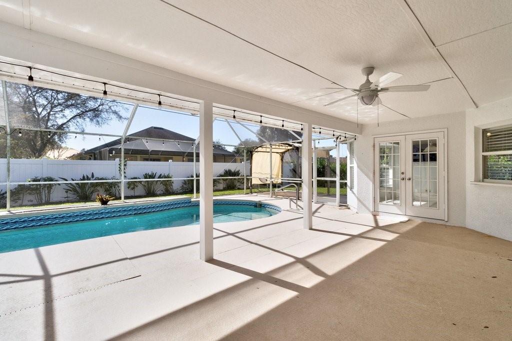 738 Benedictine Terrace Sebastian, FL 32958 - Photo 25 of 33 a living room with a floor to ceiling window and a table