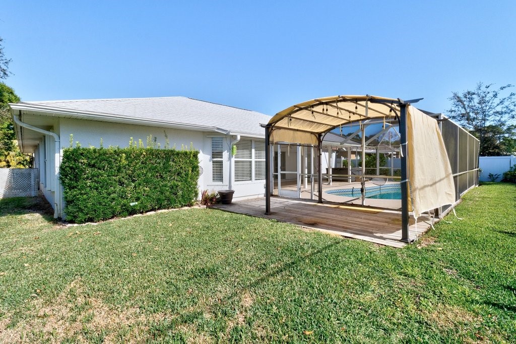 738 Benedictine Terrace Sebastian, FL 32958 - Photo 27 of 33 a view of a house with a yard and potted plants