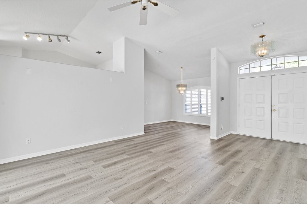 738 Benedictine Terrace Sebastian, FL 32958 - Photo 10 of 33 a view of an empty room with wooden floor