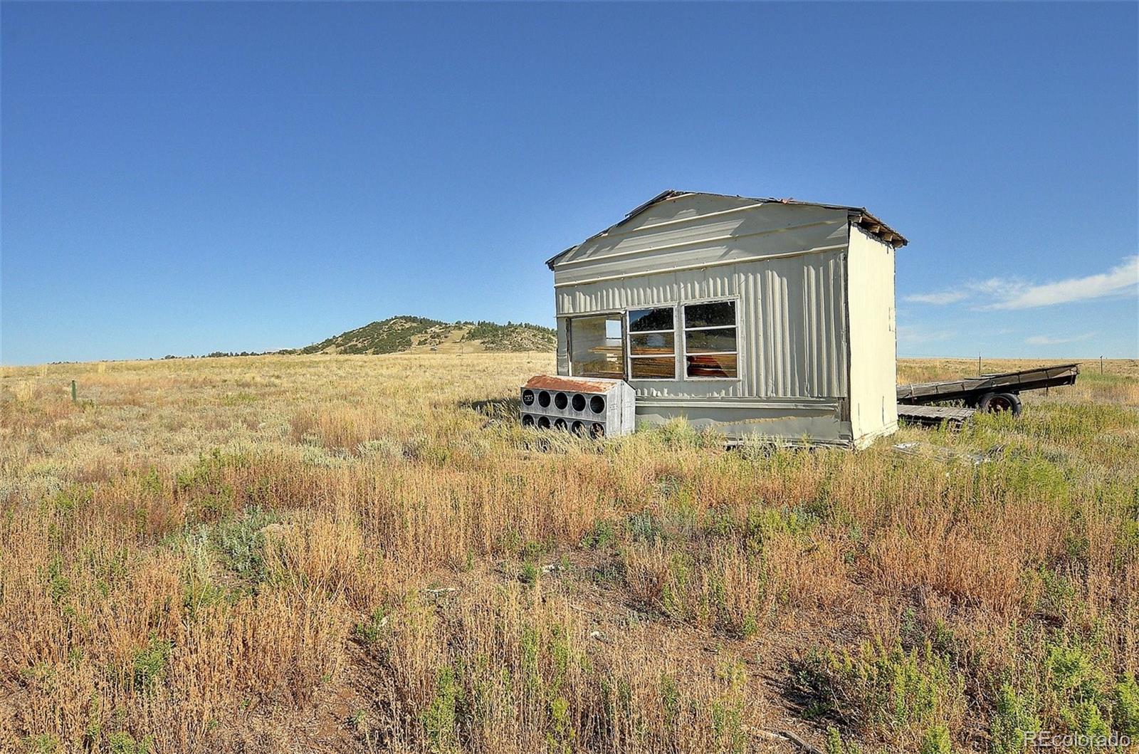 1245 Badger Creek Road Hartsel, CO 80449 - Photo 23 of 30 a view of a house with a yard