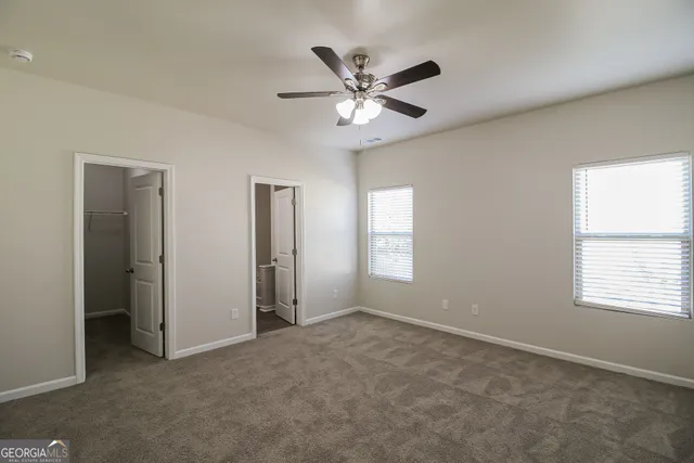 a view of a livingroom with a ceiling fan and window