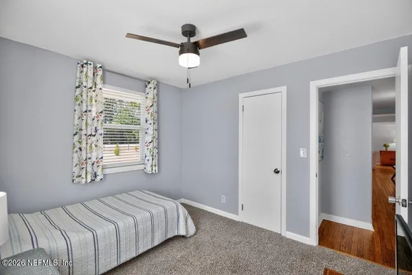 a front view of a house with a yard and trees