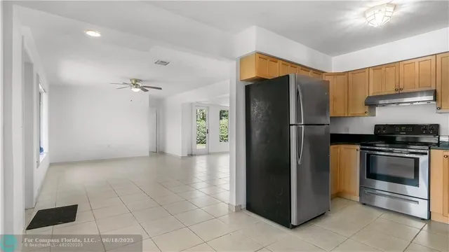 a kitchen with stainless steel appliances granite countertop a stove and a refrigerator