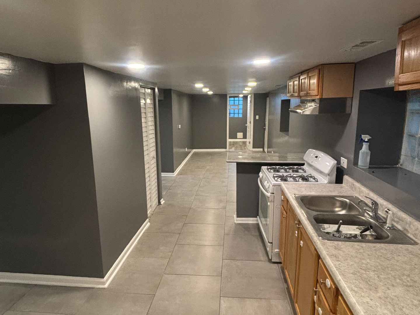 6322 South Morgan Street Chicago, IL 60621 - Photo 10 of 10 a kitchen that has a sink a stove and chairs