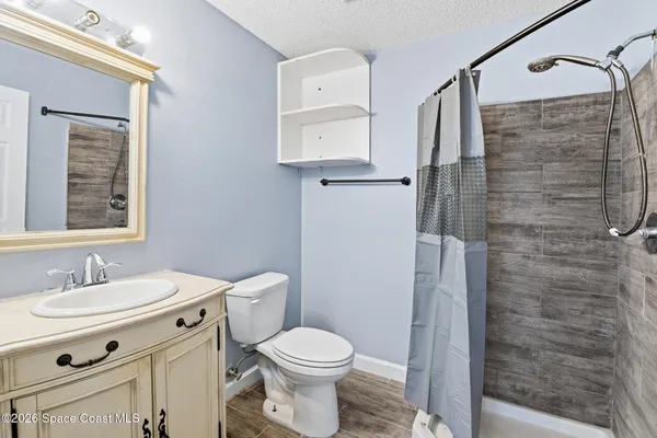 a bathroom with a toilet sink and shower