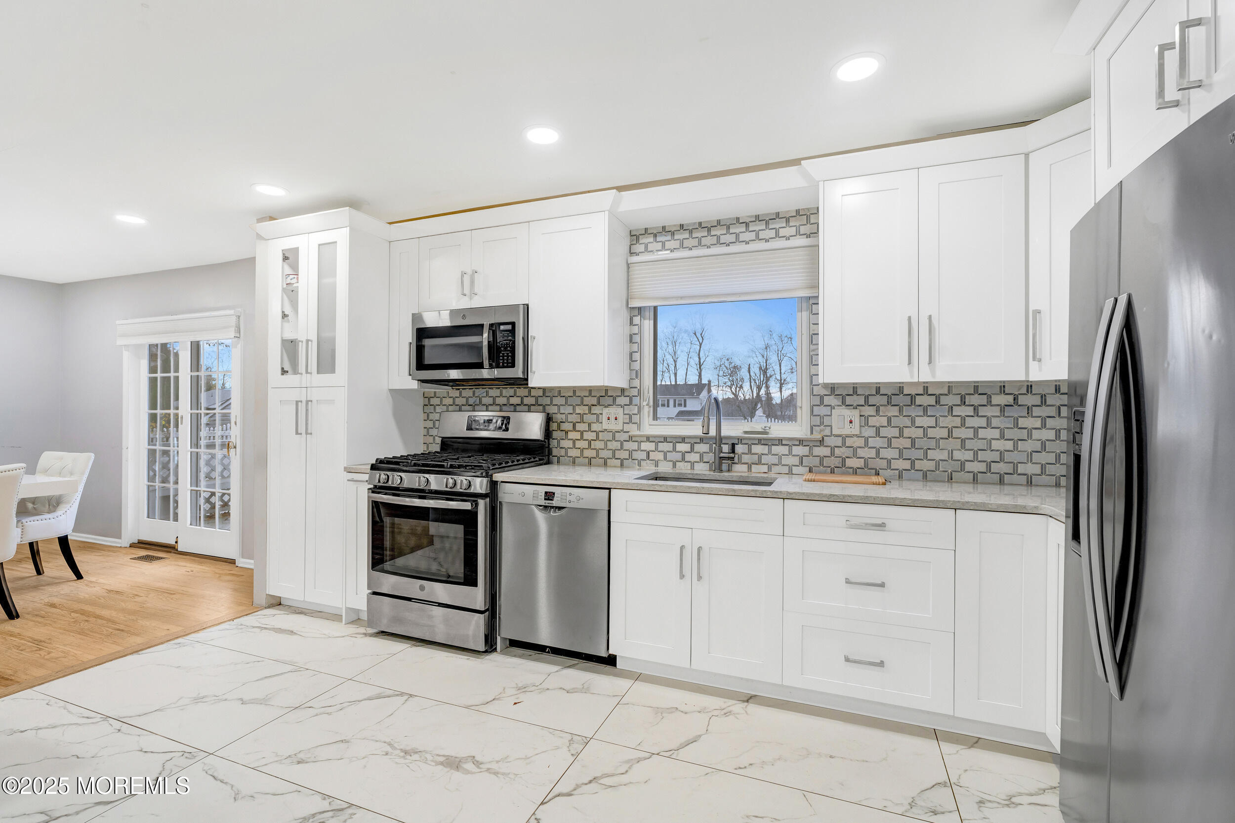104 Pear Street Oakhurst, NJ 07755 - Photo 15 of 44 a kitchen with granite countertop a refrigerator and a stove top oven