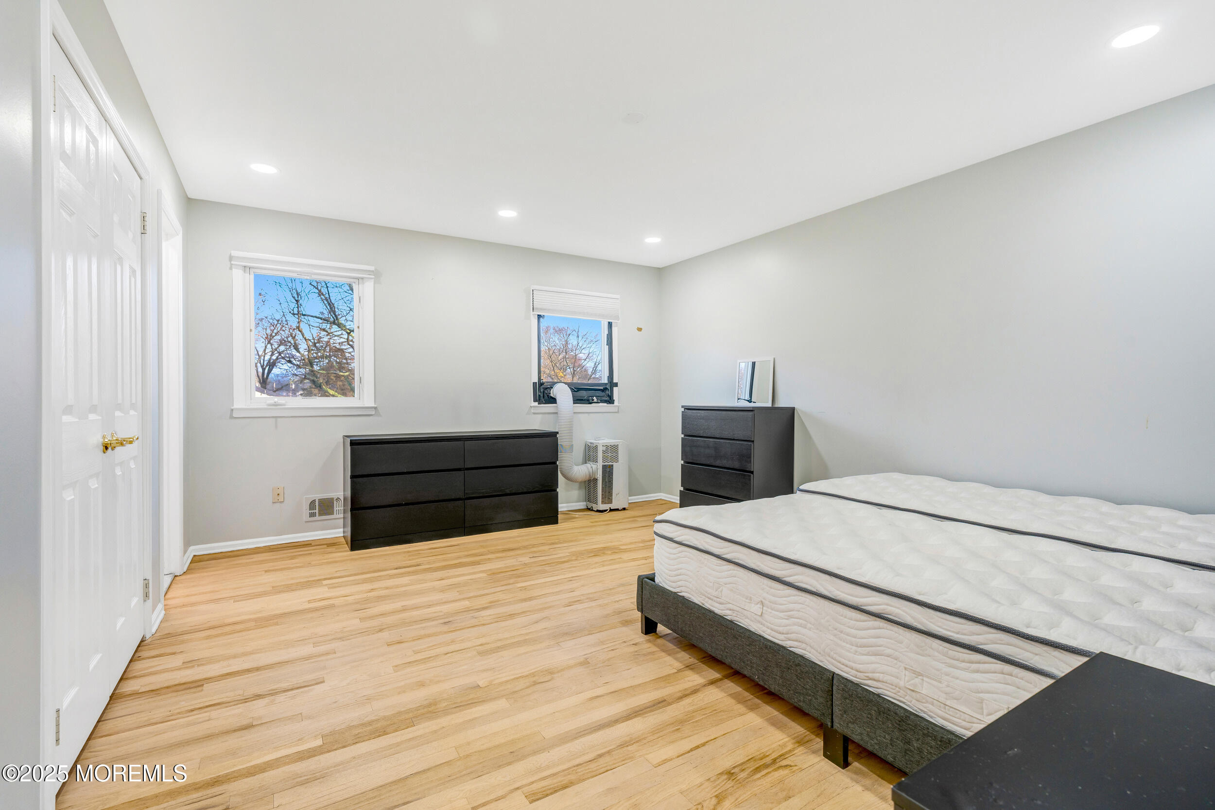 104 Pear Street Oakhurst, NJ 07755 - Photo 20 of 44 a bedroom with a large bed and a flat screen tv