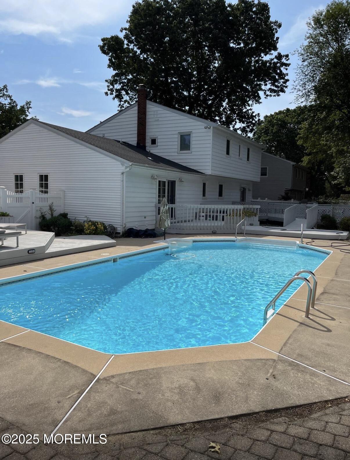 104 Pear Street Oakhurst, NJ 07755 - Photo 2 of 44 a house view with swimming pool in front of it