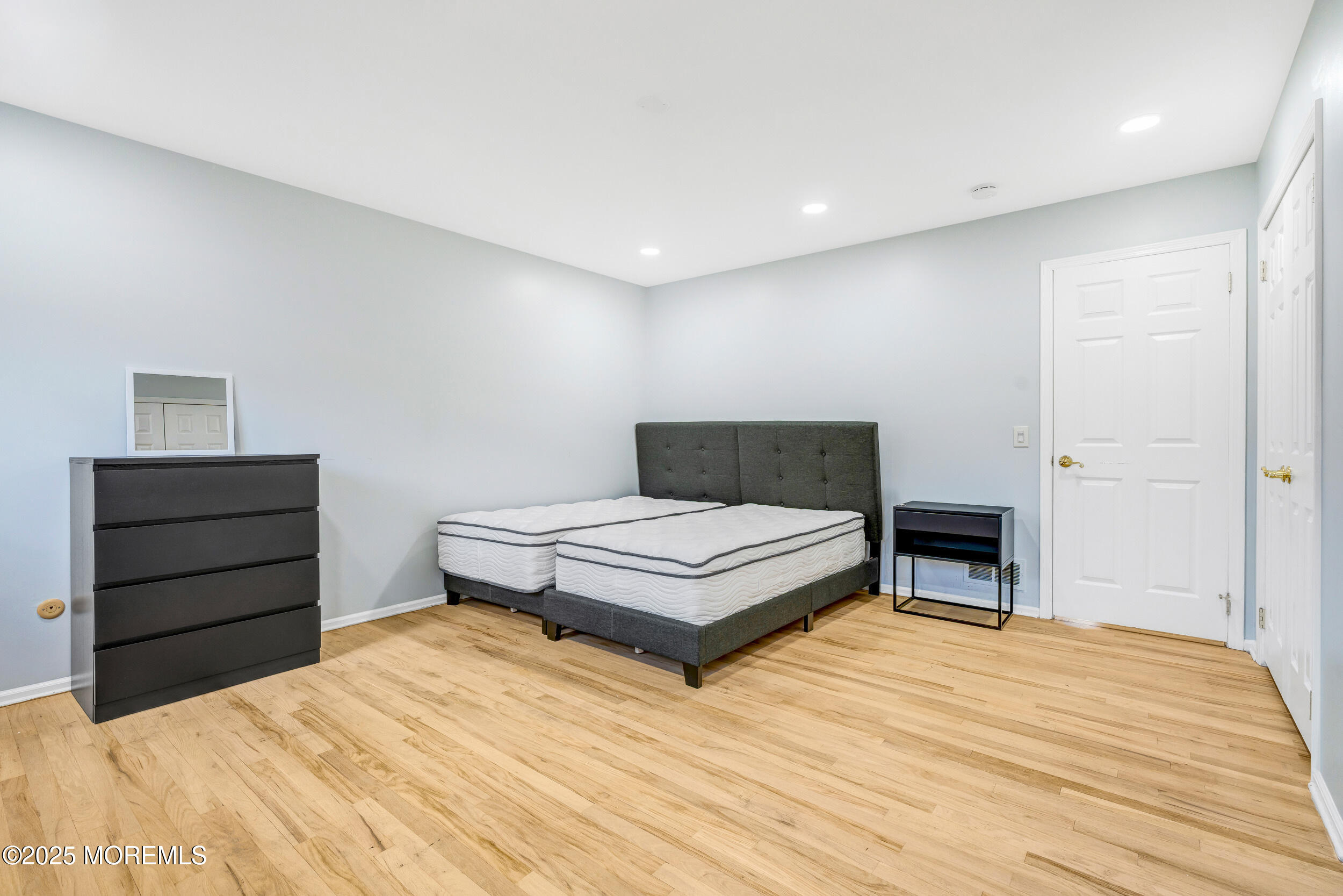 104 Pear Street Oakhurst, NJ 07755 - Photo 21 of 44 a bedroom with a bed and wooden floor