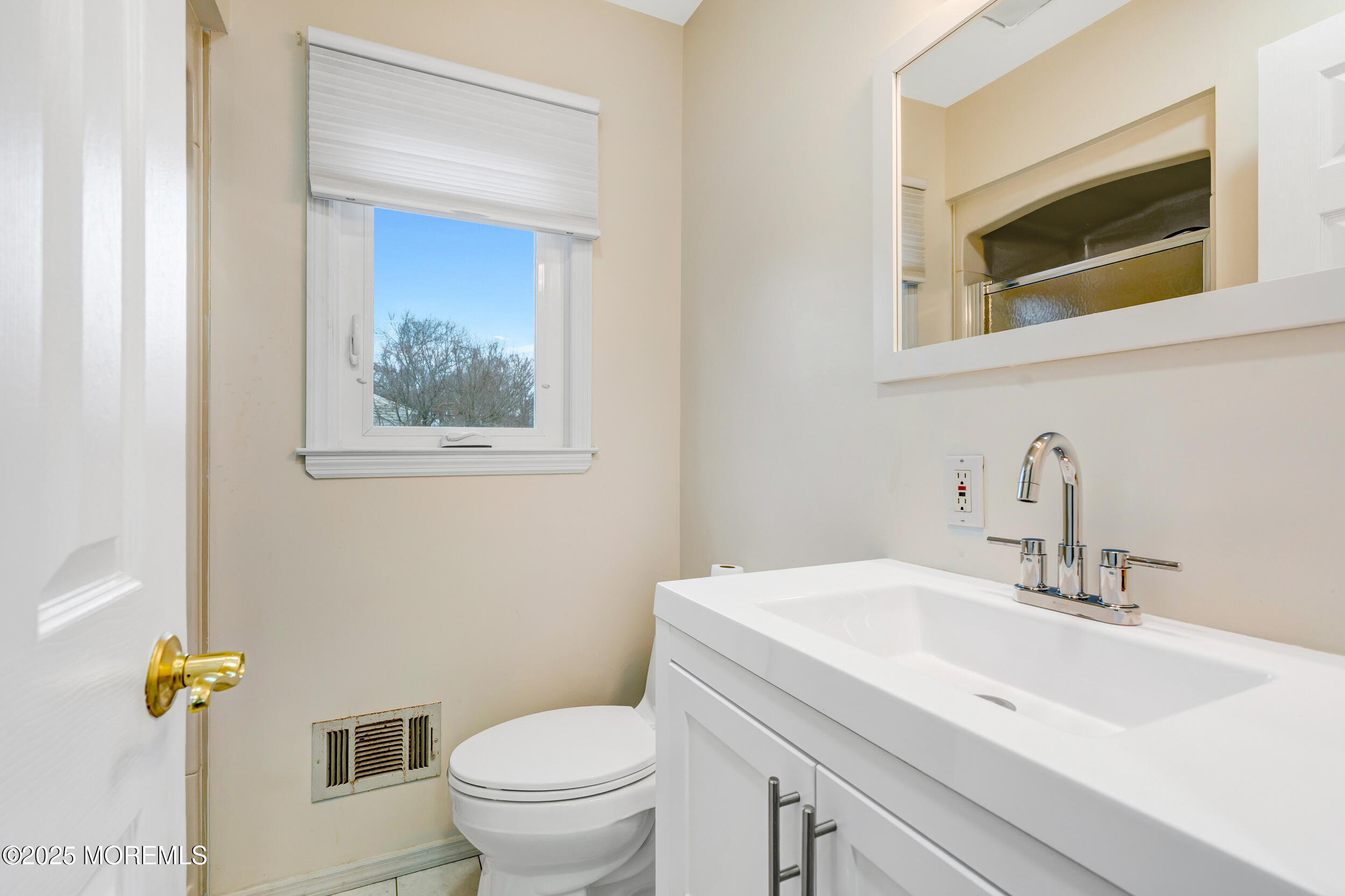 104 Pear Street Oakhurst, NJ 07755 - Photo 22 of 44 a bathroom with a sink a toilet and mirror