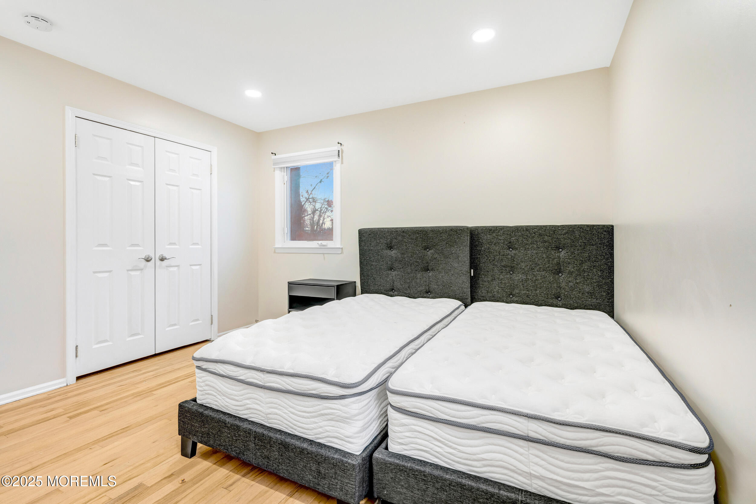 104 Pear Street Oakhurst, NJ 07755 - Photo 24 of 44 a bedroom with a bed and wooden floor