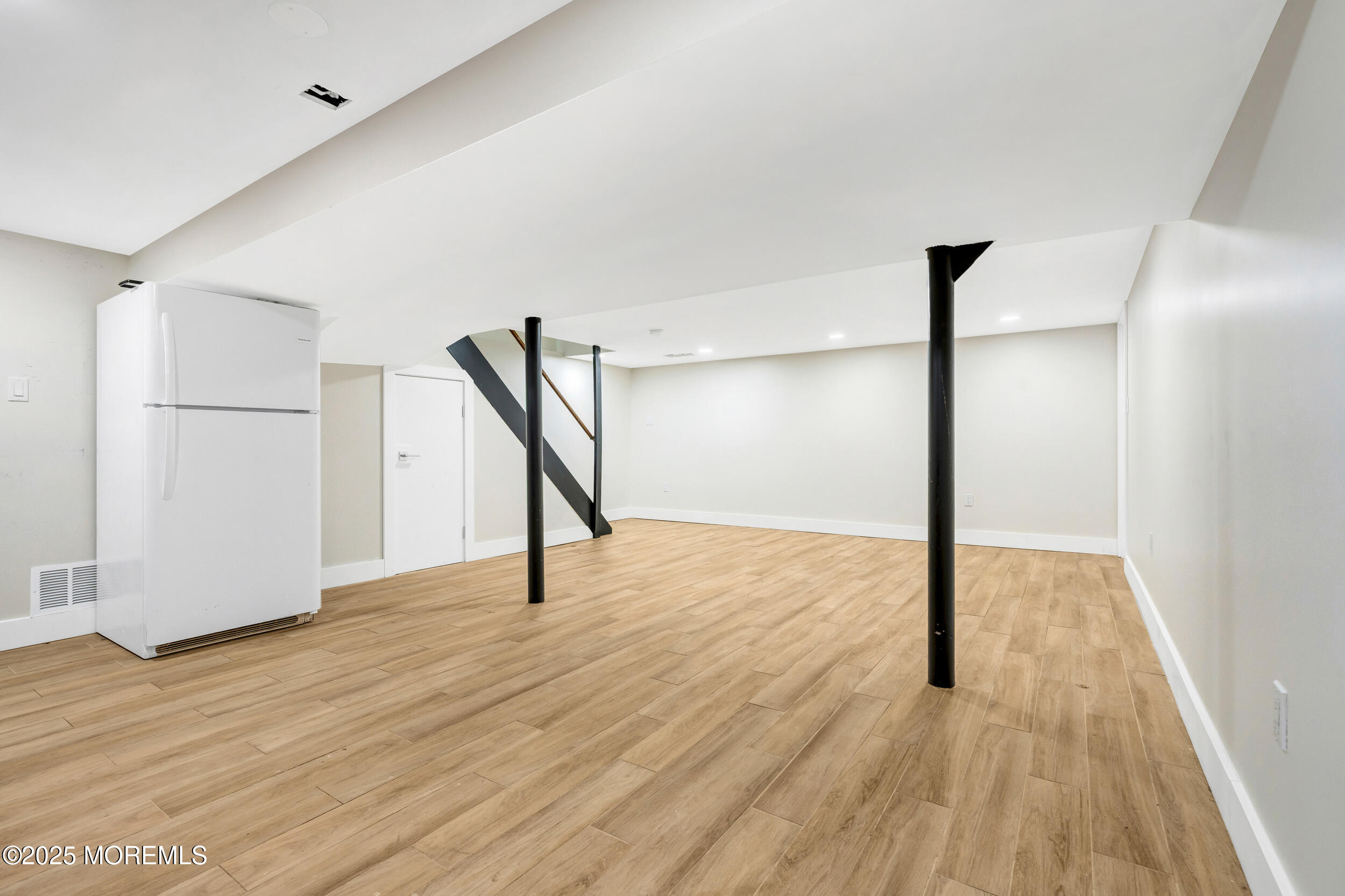 104 Pear Street Oakhurst, NJ 07755 - Photo 32 of 44 a view of an empty room with wooden floor