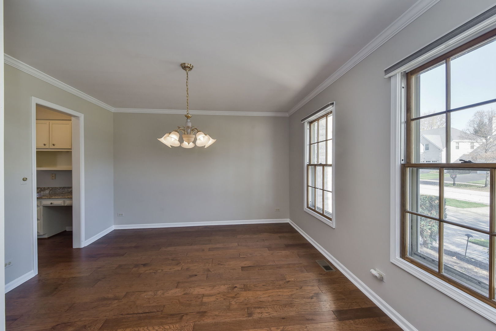 1759 Mundelein Road Naperville, IL 60565 - Photo 4 of 39 wooden floor in an empty room with a window