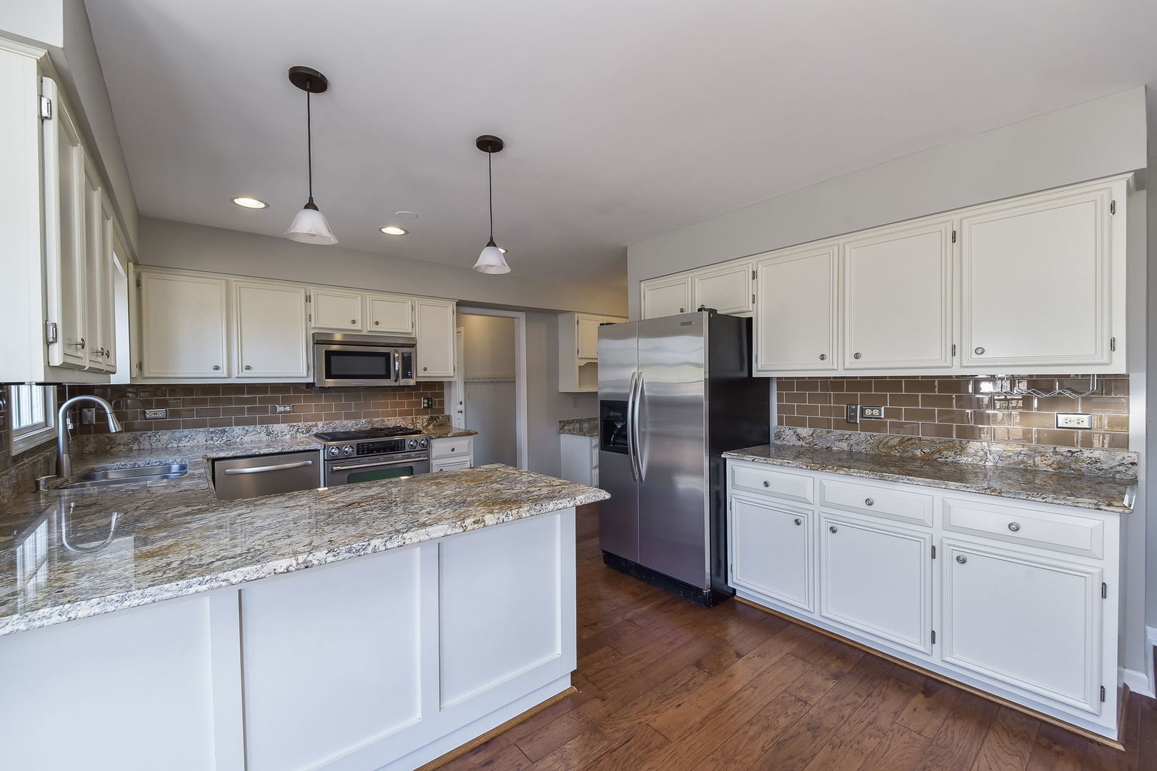 1759 Mundelein Road Naperville, IL 60565 - Photo 8 of 39 a kitchen with stainless steel appliances granite countertop a sink a stove a refrigerator cabinets and chairs