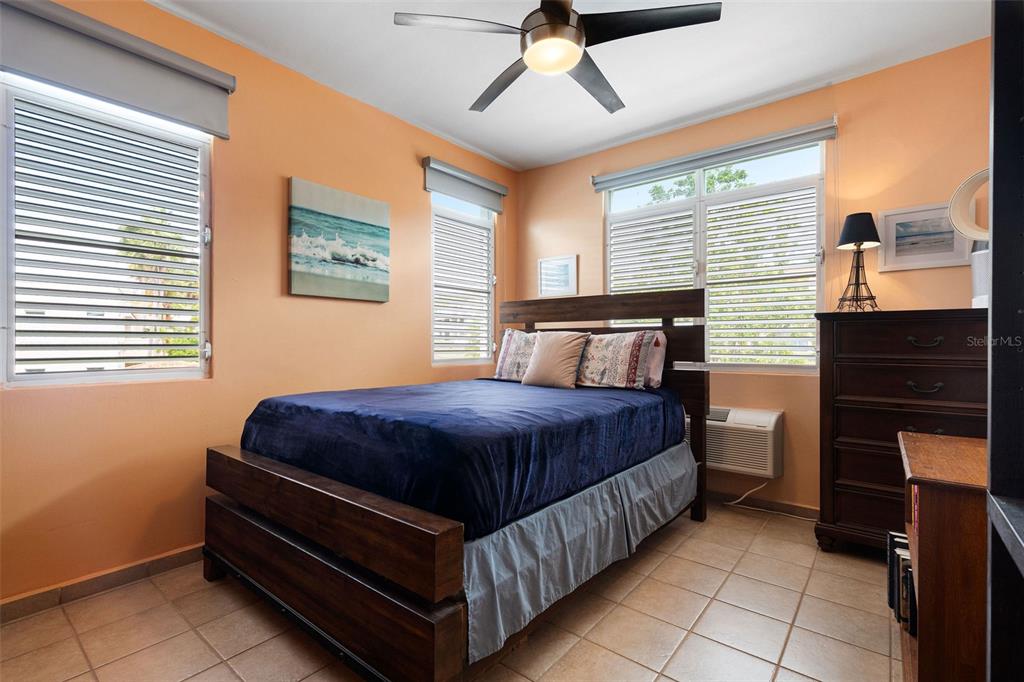 180 Palmas Drive, Unit 48C Humacao, PR 00791 - Photo 13 of 21 a bedroom with a bed and window