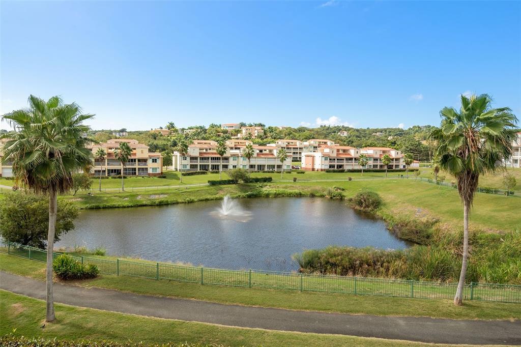 180 Palmas Drive, Unit 48C Humacao, PR 00791 - Photo 3 of 21 a view of a lake with houses in the back