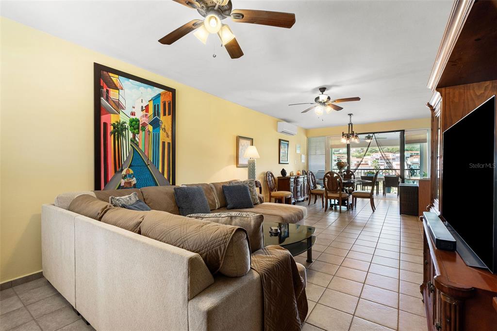 180 Palmas Drive, Unit 48C Humacao, PR 00791 - Photo 6 of 21 a living room with furniture and a flat screen tv