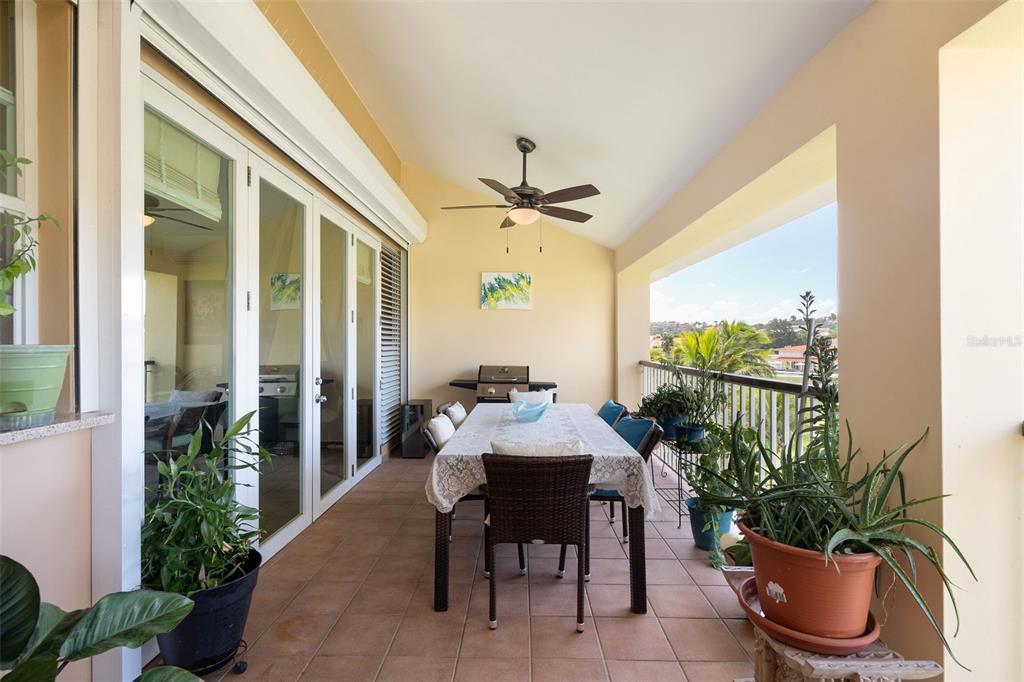 180 Palmas Drive, Unit 48C Humacao, PR 00791 - Photo 9 of 21 a dining room with furniture and potted plants
