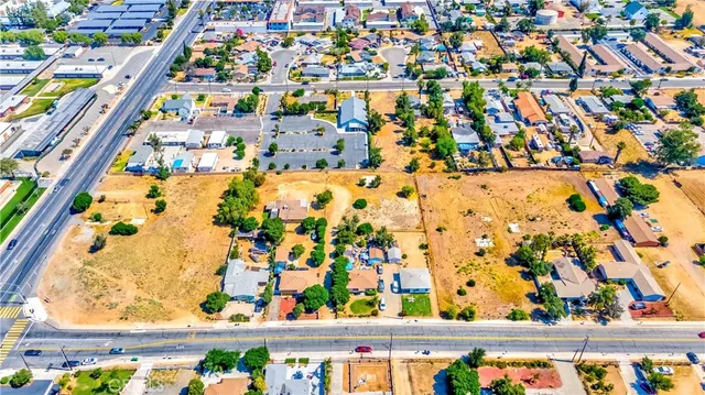 a view of a dry yard with wooden fence