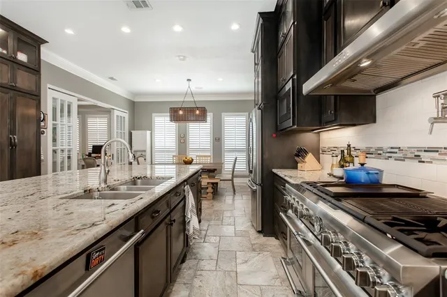 a kitchen with stainless steel appliances granite countertop a stove and a sink