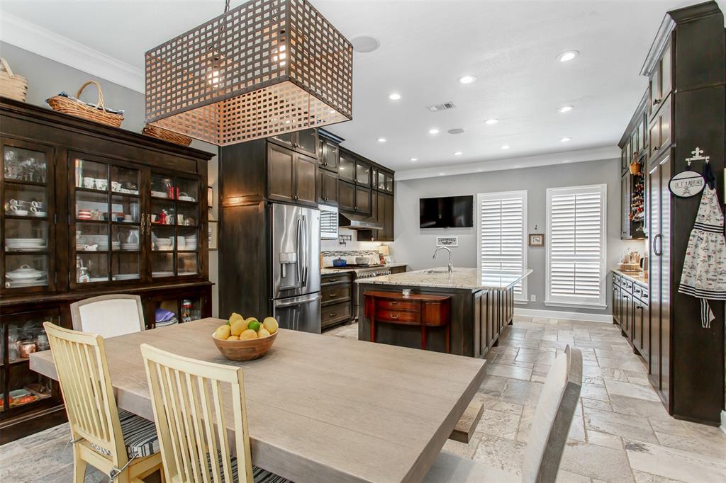 2226 City Market Lane Dallas, TX 75201 - Photo 13 of 40 a kitchen with stainless steel appliances kitchen island granite countertop a refrigerator a stove a sink a dining table and chairs with wooden floor