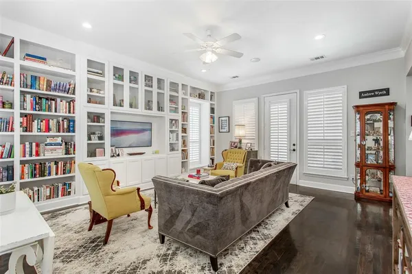 a living room with furniture and a book shelf