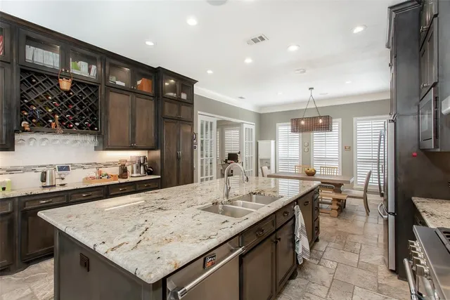 a kitchen with a stove a sink and a refrigerator