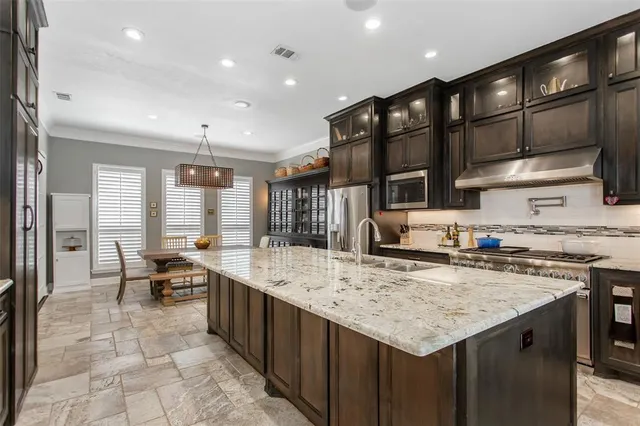 a kitchen with a stove a refrigerator and wooden cabinets