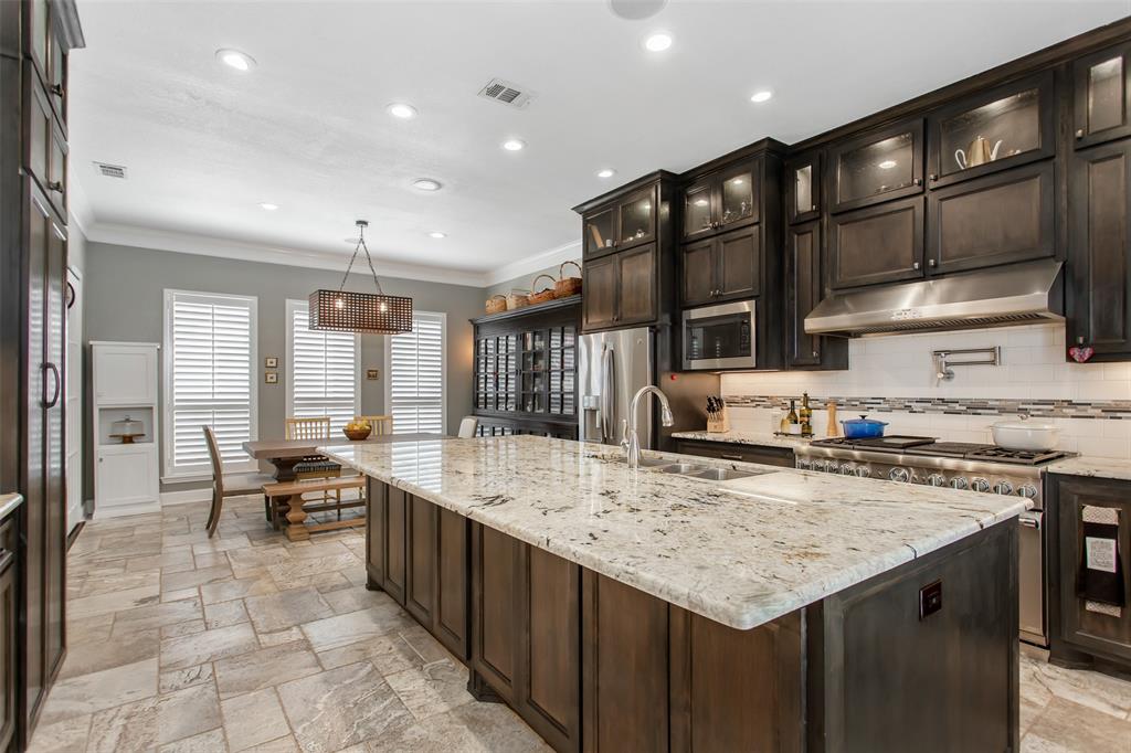 2226 City Market Lane Dallas, TX 75201 - Photo 19 of 40 a kitchen with a stove a refrigerator and wooden cabinets