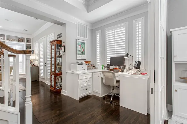 a view of a workspace with wooden floor and a window