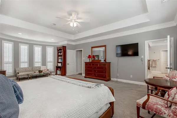 a bed room with a bed window and a television