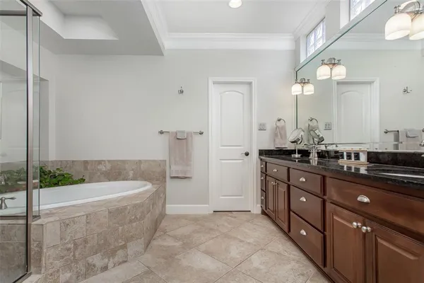 a bathroom with a tub sink and mirror