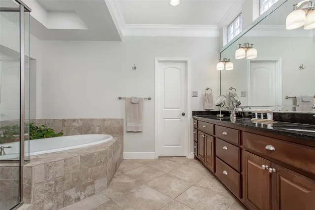 a bathroom with a tub sink and mirror