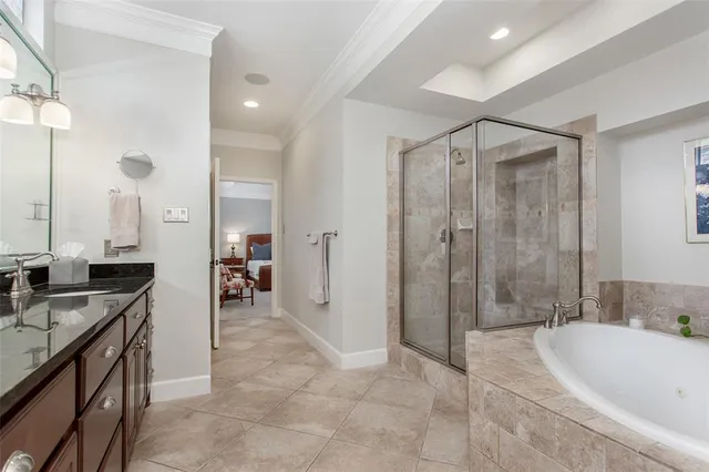 a bathroom with a granite countertop sink a mirror a bathtub and shower
