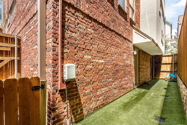 a roof deck with couch and chairs