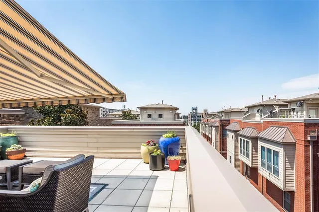 a view of a patio with couches table and chairs with wooden floor