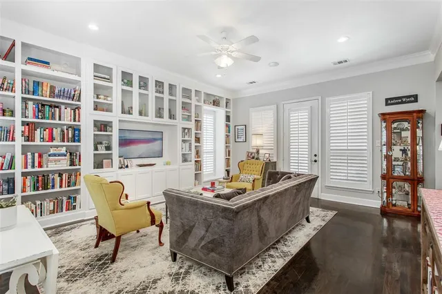 a living room with furniture and a book shelf
