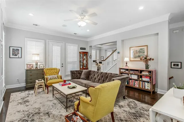 a living room with furniture and wooden floor