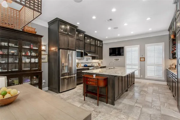 a kitchen with stainless steel appliances granite countertop a stove and a refrigerator