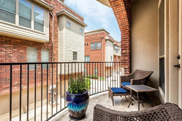 a building outdoor space with patio furniture and potted plants