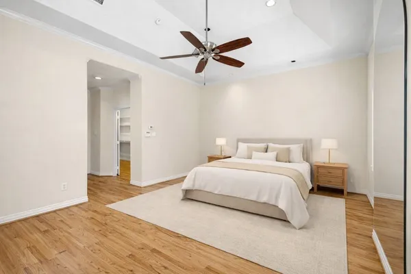 a spacious bedroom with a bed and a ceiling fan