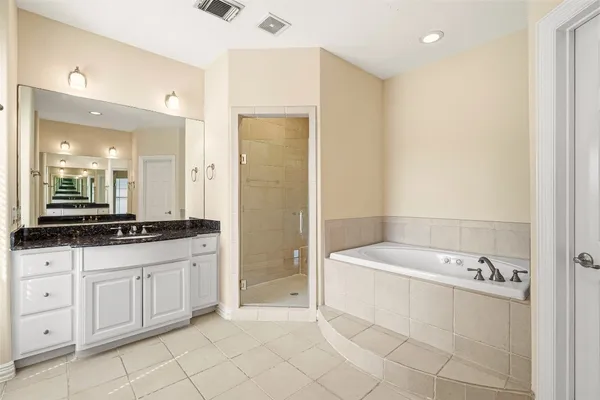 a bathroom with a bathtub sink and mirror