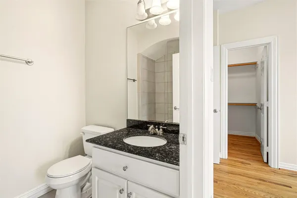 a bathroom with a granite countertop sink toilet and shower
