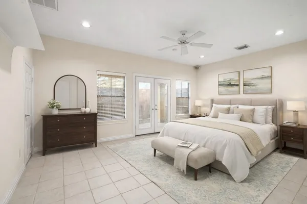 a spacious bedroom with a bed and a dresser