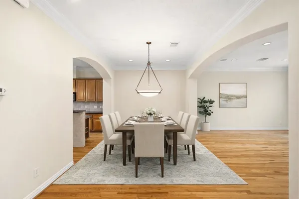 a dining room with furniture window and wooden floor