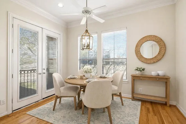 a living room with furniture a window and wooden floor