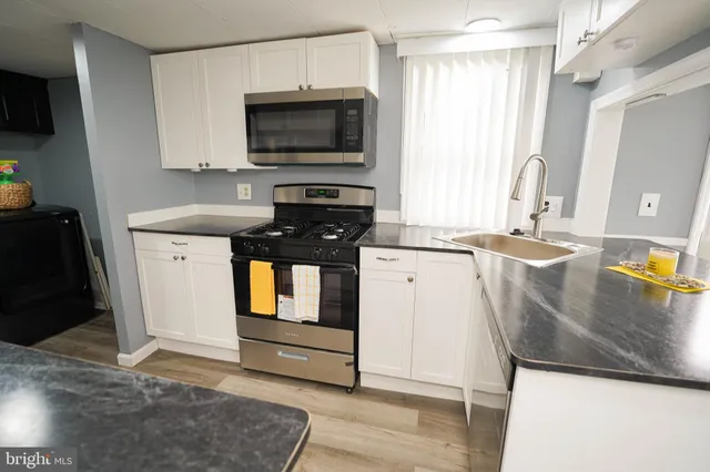 a kitchen with a sink and a stove top oven