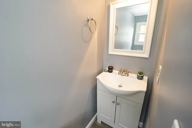 a bathroom with a sink a toilet and mirror