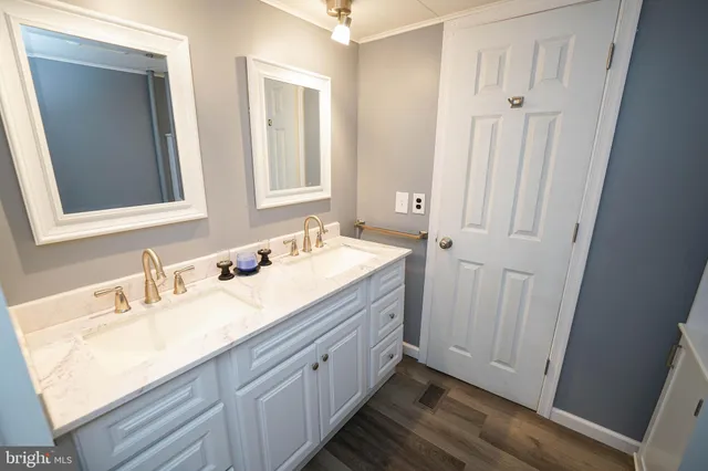 a bathroom with a double vanity sink and mirror