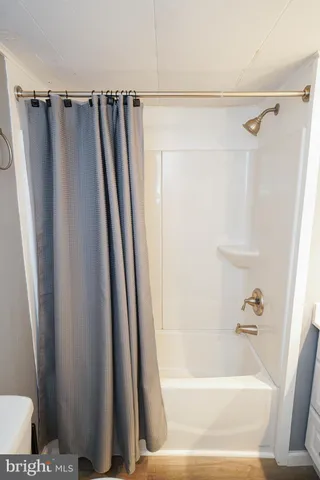 a bathroom with a shower and a tub